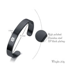 Black medical ID cuff bangle detail showing the stainless steel body and personalized engraving area.