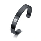 Side view of a black stainless steel medical ID cuff bangle showing its smooth curved shape.