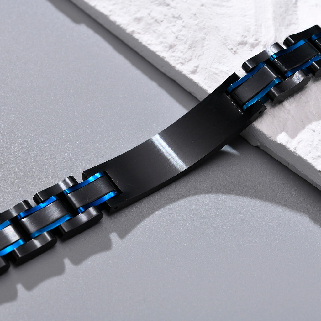 Close-up of the black medical ID plate and blue accent links on a stainless steel bracelet.