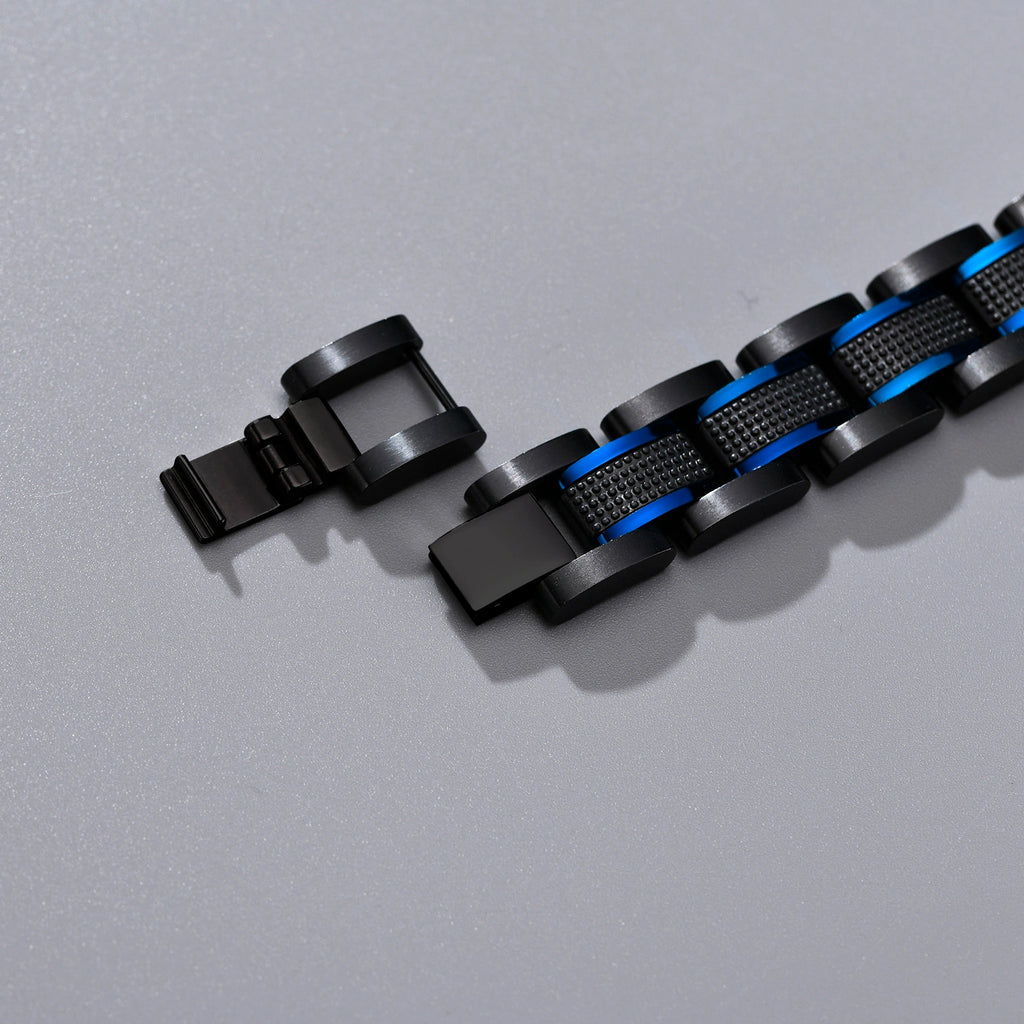 Detail view of the clasp and blue accent links on a black stainless steel medical ID bracelet.