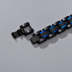 Detail view of the clasp and blue accent links on a black stainless steel medical ID bracelet.