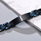 Close-up of a black and blue medical ID link bracelet showing the stainless steel ID plate and links.