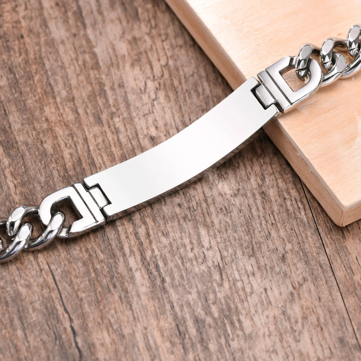 Back view of a stainless steel medical ID curb chain bracelet showing the smooth personalized engraving area