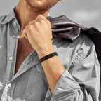 Man wearing a black stainless steel medical ID link bracelet on his wrist.