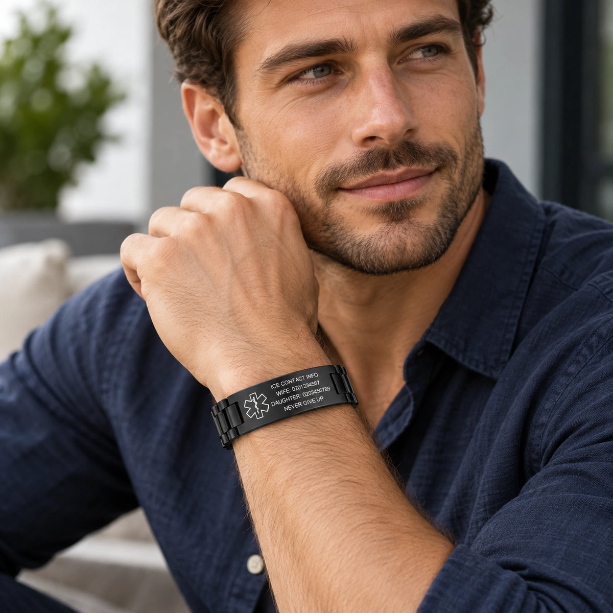 Man wearing a black stainless steel medical ID link bracelet on his wrist.
