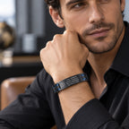 Man wearing a black and blue stainless steel medical ID link bracelet on his wrist.