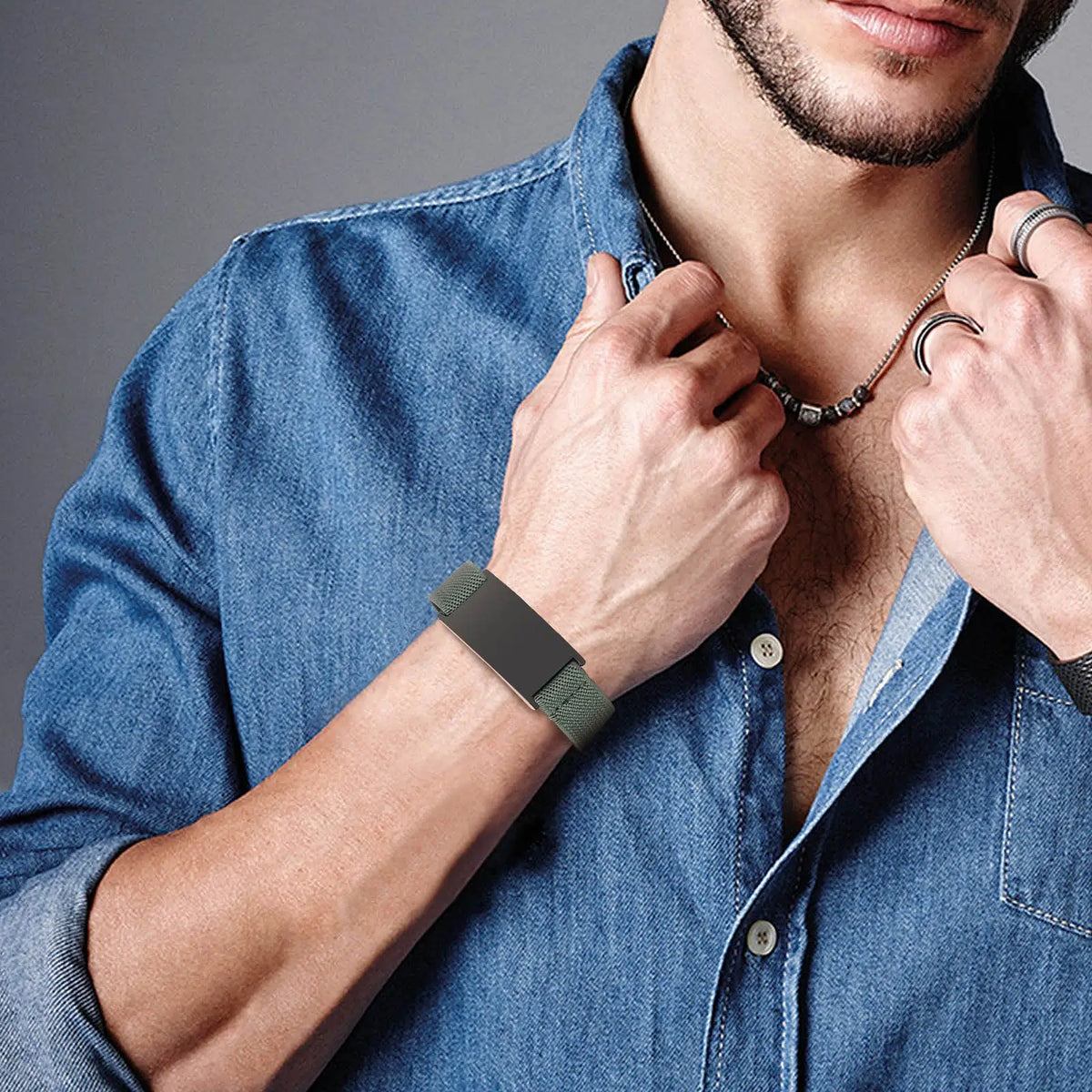 Man wearing a black medical ID bracelet with an adjustable elastic band on his wrist.