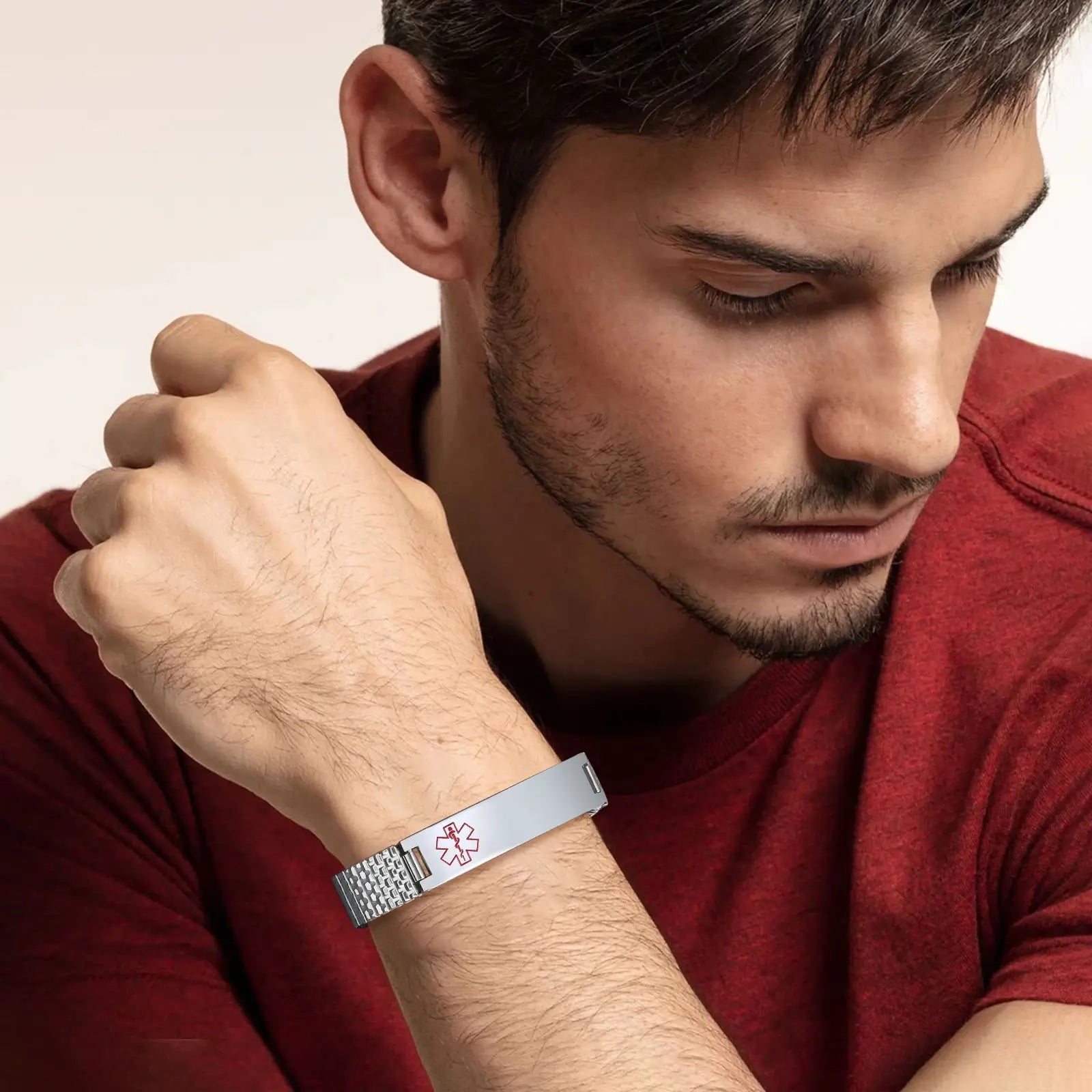 Man wearing a silver stainless steel medical ID stretch bracelet on his wrist.