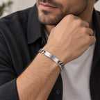 Man wearing a silver stainless steel ID chain bracelet on his wrist.