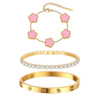 Three-piece gold tone bracelet set featuring five pink acrylic flower charms, a sparkling CZ tennis bracelet, and a stainless steel crystal bangle.