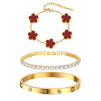 Three-piece gold tone bracelet set featuring five red acrylic flower charms, a sparkling CZ tennis bracelet, and a stainless steel crystal bangle.