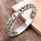 Close-up of a silver stainless steel medical ID bracelet with chunky curb chain and adjustable engraving plate
