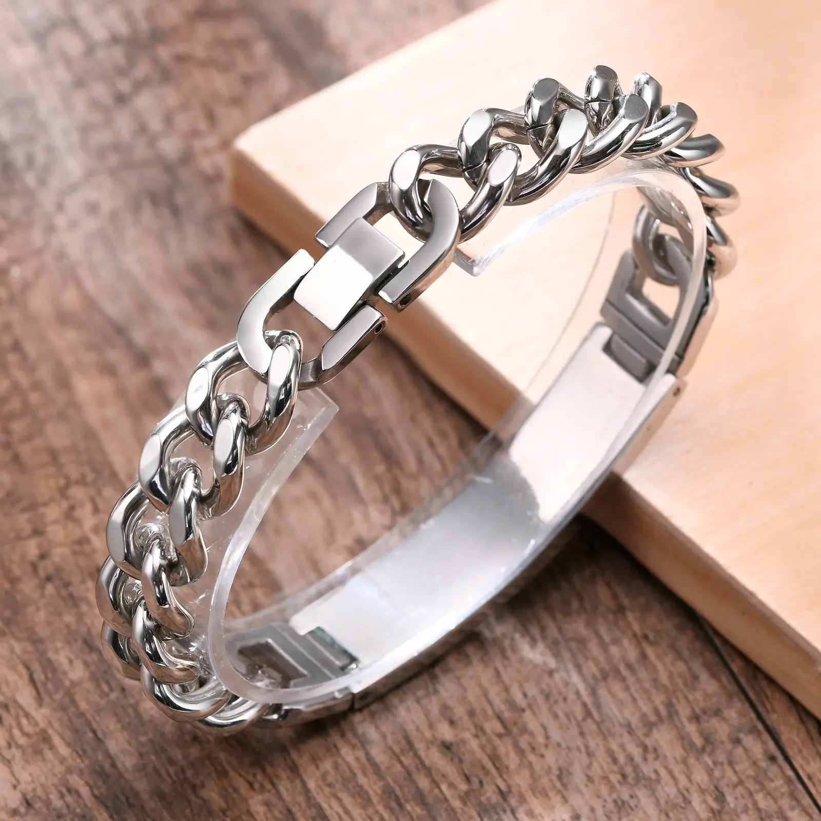 Close-up of a silver stainless steel medical ID bracelet with chunky curb chain and adjustable engraving plate