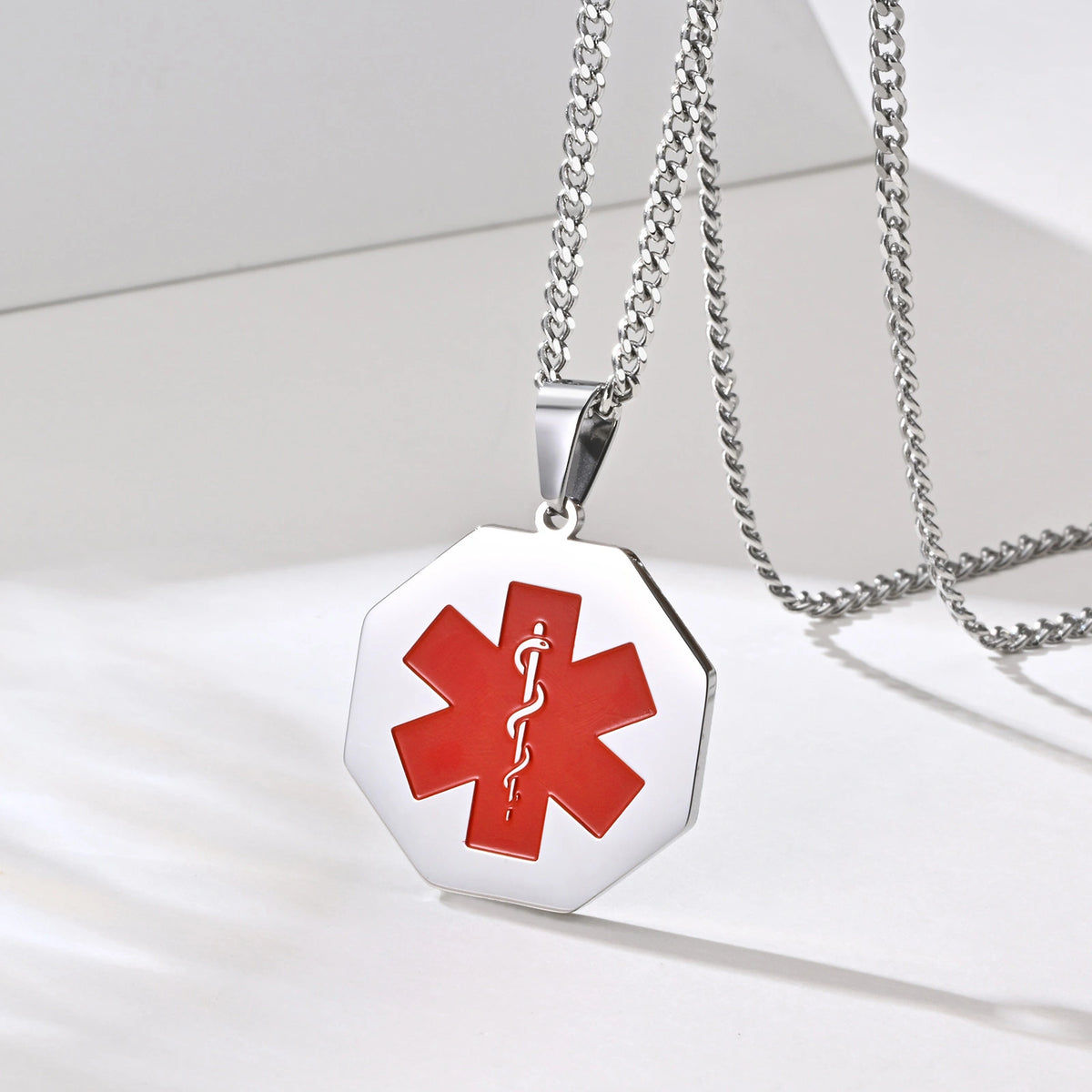 Silver octagonal medical ID necklace displayed with stainless steel chain and red medical symbol.