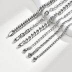 Close-up of polished stainless steel chain bracelets arranged diagonally, highlighting different link patterns, textures, and silver finishes.