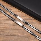 Close-up of a silver stainless steel ID bracelet showing the polished plate and chain links.