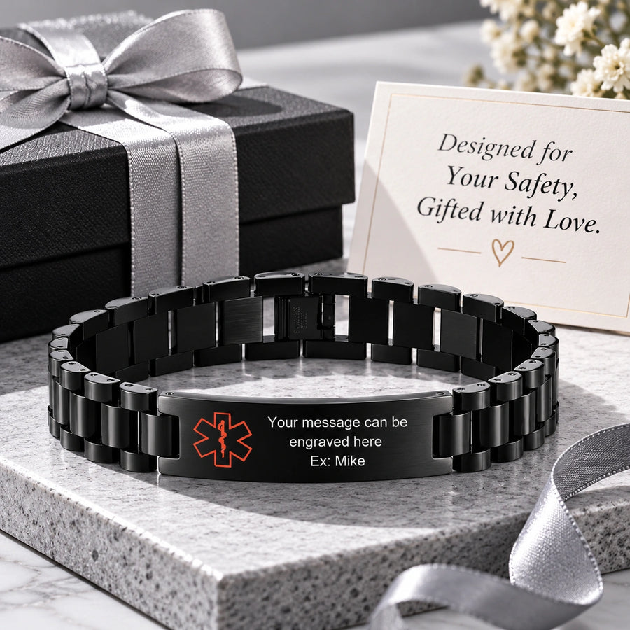 Black stainless steel medical ID bracelet displayed beside a ribbon-wrapped gift box and a card reading Designed for Your Safety, Gifted with Love