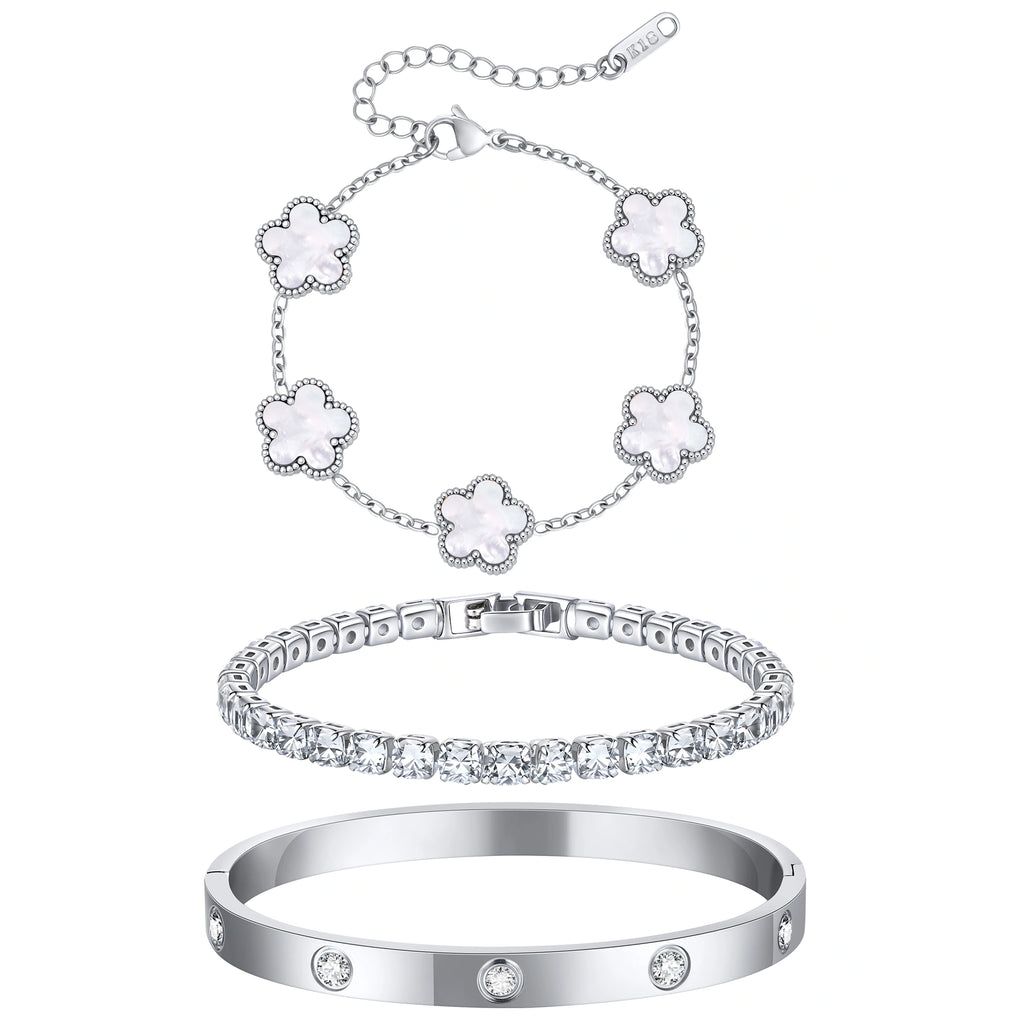 Three-piece silver tone bracelet set featuring five white mother of pearl flower charms, a sparkling CZ tennis bracelet, and a stainless steel crystal bangle.
