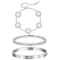 Three-piece silver tone bracelet set featuring five white mother of pearl flower charms, a sparkling CZ tennis bracelet, and a stainless steel crystal bangle.