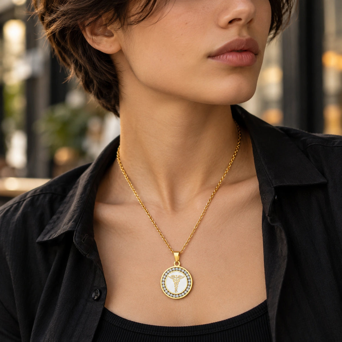 Woman wearing a gold round medical ID necklace with sparkling CZ accents and medical symbol.