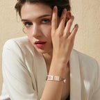 Woman wearing a rose gold stainless steel mesh medical ID bracelet on her wrist.